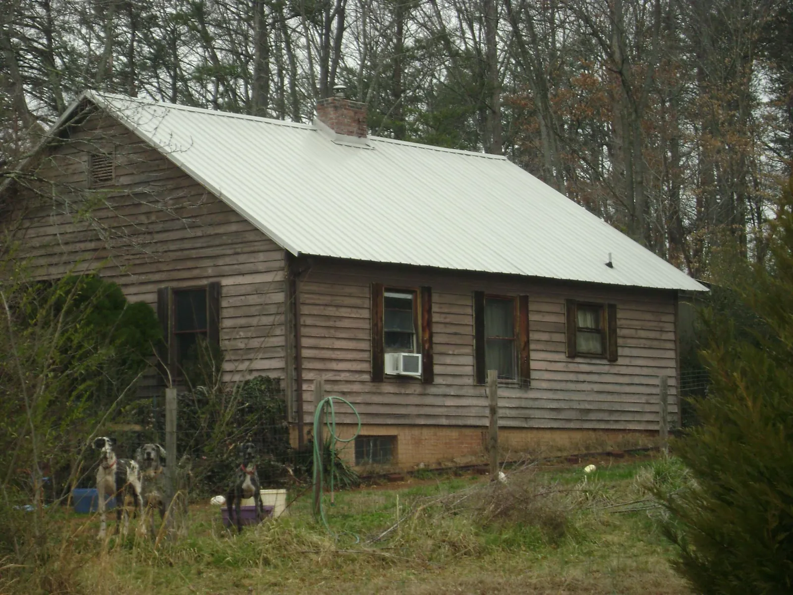 White metal roof on an old wood sided farmhouse, from a Metal Roof Installation job in Chokio